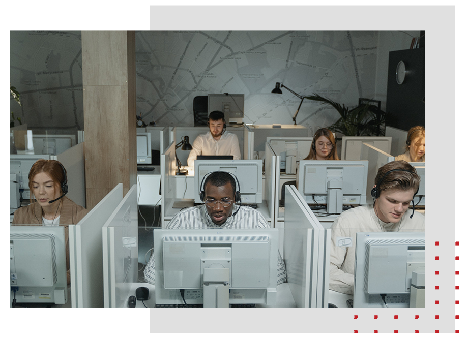 A call center with a group of people talking while on computer.