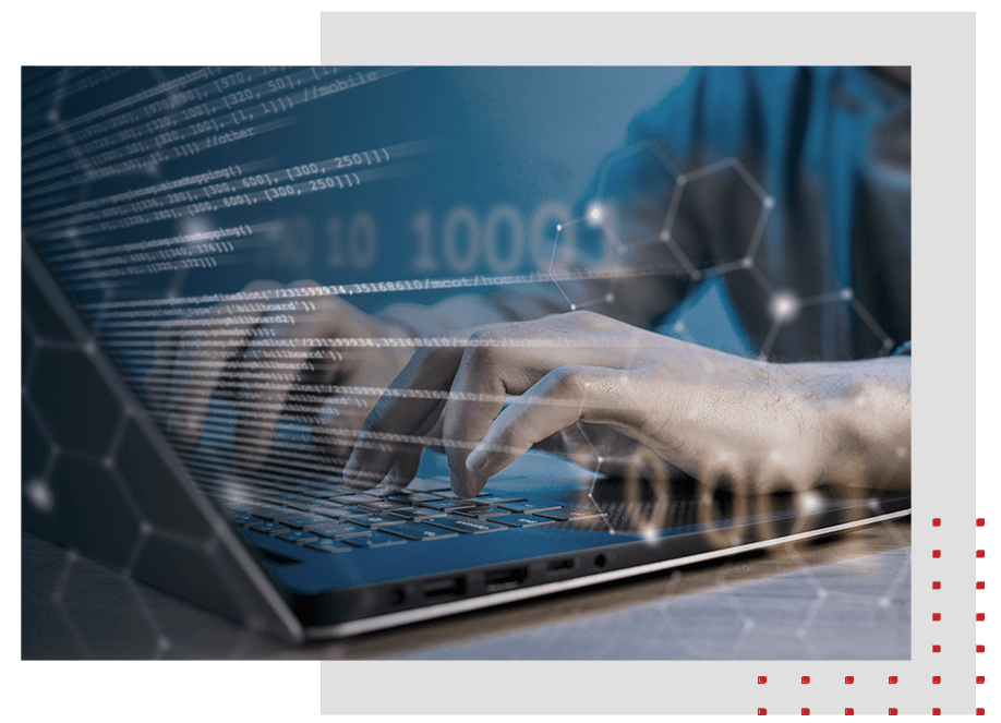 Hands typing on laptop with faded code overlayed.
